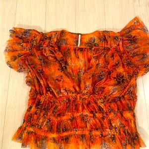 Free people top. Size large but runs small. Slightly cropped.